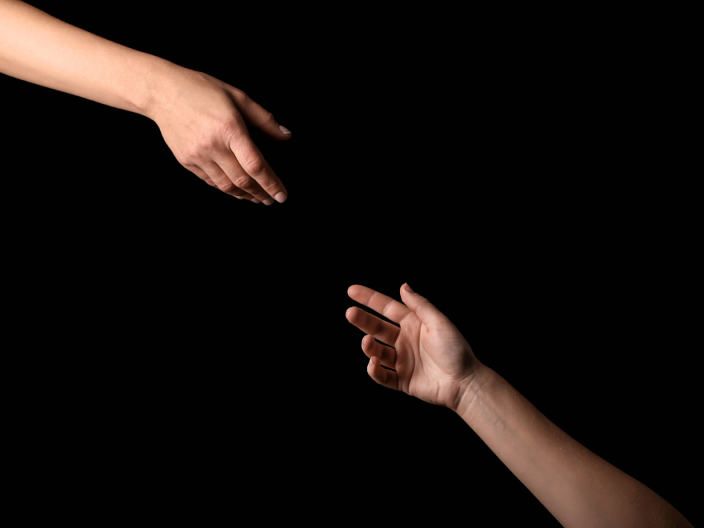 A pair of hands reaching out to another hand offering support. This symbolizes the core function of EAPs: providing assistance.