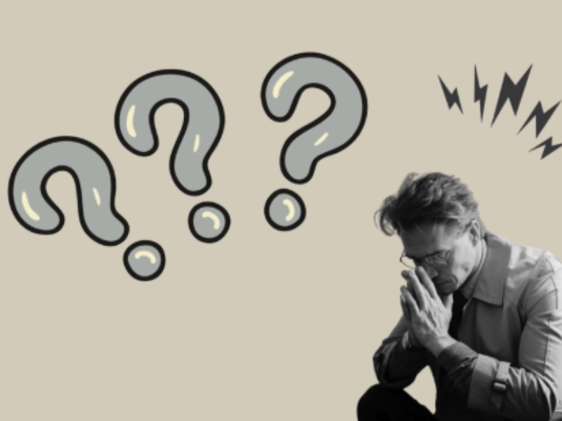 A man with his head bowed, a question mark above him, deep in thought or contemplation.