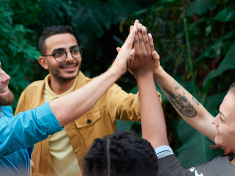 Team celebrating with a high five.