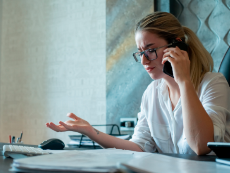 Woman on phone with documents