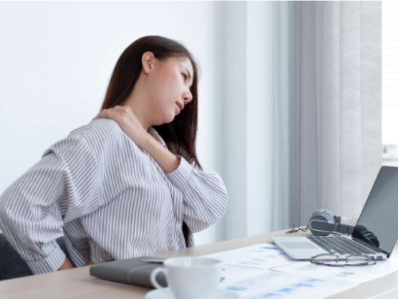 Woman rubbing her lower back in discomfort